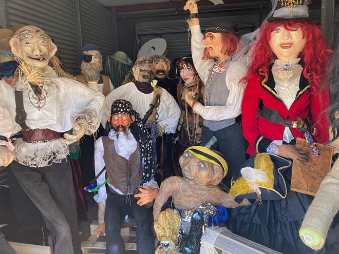 Scarecrows in storage awaiting being placed on display