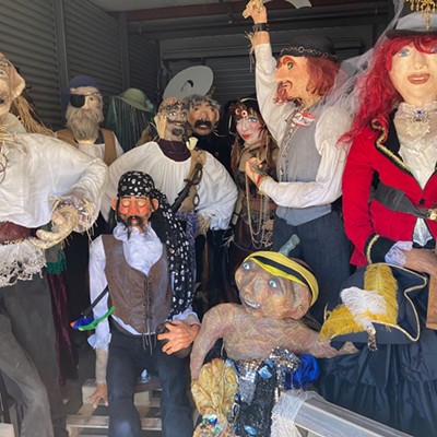 Scarecrows in storage awaiting being placed on display