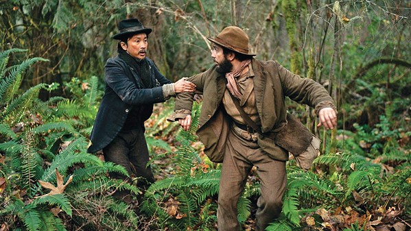 FRIENDS IN FLIGHT Ling-Lu (Orion Lee) and Otis "Cookie" Figowitz (John Magaro) forge a friendship in dangerous 1820 Oregon, as they try to make their fortune, in First Cow, available through various streaming services. - PHOTO COURTESY OF A24