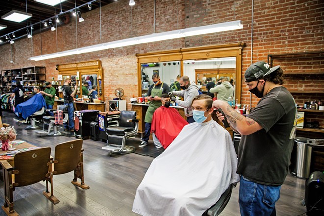 TIME FOR A CUT? Nic Cano cuts Ben Schlesier's hair at The Ritual, which doubles as a men's clothing (and other cool things) store and won Best Barber Shop. - PHOTO BY JAYSON MELLOM