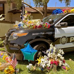 IN THE LINE OF DUTY Community members are leaving balloons and flowers outside the San Luis Obispo Police Department to memorialize SLO Police Detective Luca Benedetti. - PHOTO COURTESY OF SLOPD FACEBOOK