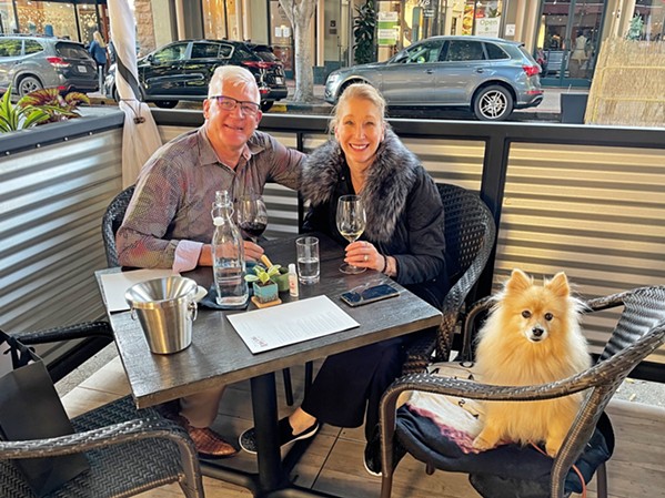 TABLE FOR THREE Customers Jeff and Pam Forrest and their Pomeranian, 13-year-old Rambeau, enjoy the patio area fronting the tasting room. - PHOTO BY CHERISH WHYTE