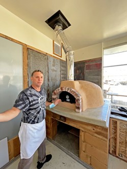 BAKE, BABY, BAKE Colony Market &amp; Deli manager Mark Elterman shows off their new wood-fired pizza oven, which will soon be churning out Neapolitan-style pies. - PHOTOS BY GLEN AND ANNA STARKEY