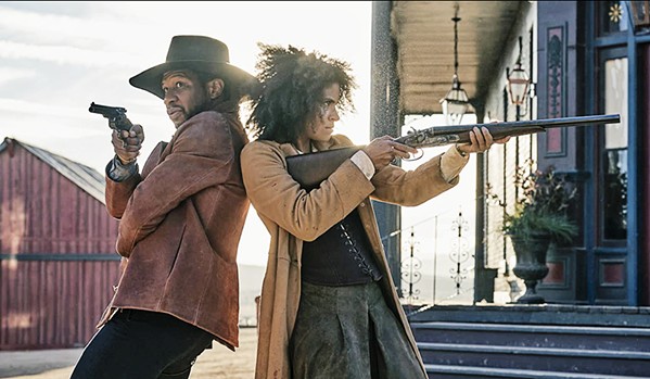 HISTORICAL FANTASTICAL Nat Love (Jonathan Majors) and Stagecoach Mary Fields (Zazie Beetz) shoot it out with a rival gang, in The Harder They Fall, a revisionist Black Western streaming on Netflix. - PHOTO COURTESY OF OVERBROOK ENTERTAINMENT