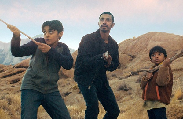 FIGHTING ALIENS Former U.S. Marine Malik Khan (Riz Ahmed, center) rescues his sons Jay (Lucian-River Chauhan, left) and Bobby (Aditya Geddada) during an alien invasion no one seems to be aware is happening, in the paranoid sci-fi thriller Encounter, screening for free with your membership on Amazon Prime. - PHOTO COURTESY OF AMAZON STUDIOS
