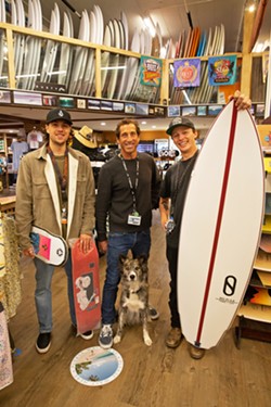 SURFBOARD SPOT Central Coast Surfboards owner Scott Smith (center) hangs out in New Times' readers favorite place to buy a board with his dog, Neela; Brennen Grimm (left), and Seth Dignan (right). - PHOTO BY JAYSON MELLOM