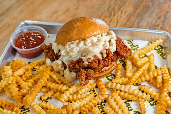 SAY CHEESE This is the Mac Daddy in all its glory: Jay Bird's Nashville hot chicken sandwich, prepared at the spice level of your choice, topped with creamy mac and cheese with a side of crinkle-cut fries. - PHOTOS COURTESY OF JAY BIRD'S