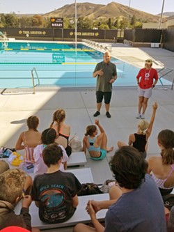 POOL PARTY San Luis Coastal school district's Summer Experience included swim classes. Instructor Chris Jones prepares students for safety on the first day of summer swim class. - PHOTO COURTESY OF SAN LUIS COASTAL UNIFIED SCHOOL DISTRICT