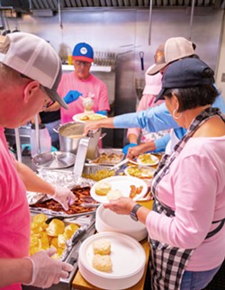 COMMUNITY SUPPORT Volunteers help serve food at last year’s Brunch, Bubbles, and Boobs, the annual fundraiser held by Real Men Wear Pink, a group of community leaders that helps increase breast cancer awareness. - COURTESY PHOTO BY SIMON MERCADO PHOTOGRAPHY