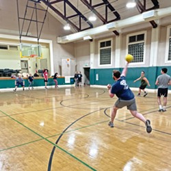 WINDING UP New Times ad rep Drew Gilmore heaves a dodgeball across the court during a Jan. 23 game. - PHOTOS BY PETER JOHNSON