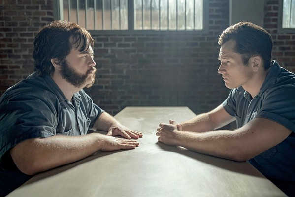 CAT AND MOUSE Prison snitch Jimmy Keene (Taron Egerton, right) must coax out a confession from serial killer Larry Hall (Paul Walter Hauser) before he winds up dead, in the true crime story Black Bird, streaming on Apple TV Plus. - PHOTO COURTESY OF THE ASYLUM
