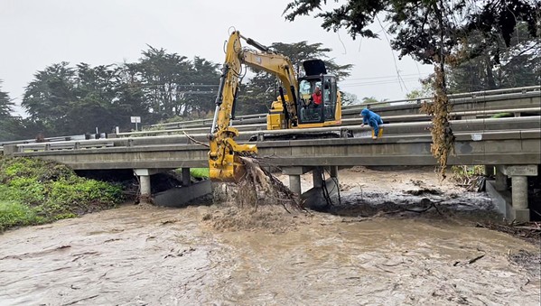CLAW GRAB To alleviate the flooding in Morro Bay, the city had an excavator stationed on the Main Street Bridge to clear out any debris.&nbsp; - PHOTO COURTESY OF THE CITY OF MORRO BAY