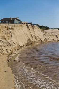 WASHED AWAY Arroyo Grande Creek steadily flows into the Pacific Ocean after a series of winter storms, taking out large chunks of sand as it meets the saltwater in Oceano. - PHOTO BY JAYSON MELLOM
