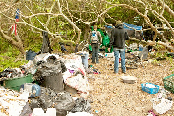 STILL HERE Residents of the homeless encampment along Quintana Road and Highway 1(pictured in 2012) have historically and recently felt the impact of winter storms&mdash;seeing their camps cause debris to build as rainwater sweeps through the drainage area they live in. - FILE PHOTO BY STEVE E. MILLER