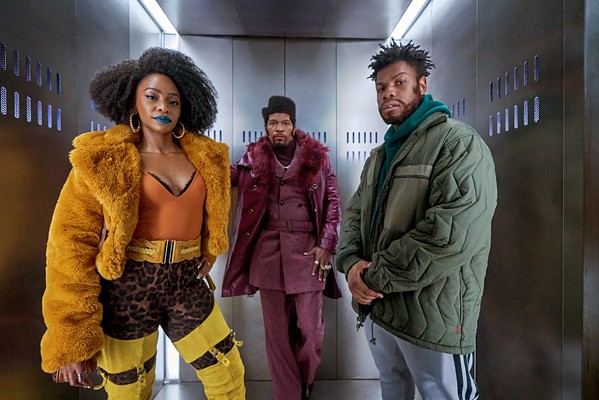 BLAXPLOITATION HOMAGE (Left to right) Yo-Yo (Teyonah Parris), Slick Charles (Jamie Foxx), and Fontaine (John Boyega) join forces to unravel a neighborhood mystery, in They Cloned Tyrone, streaming on Netflix. - PHOTO COURTESY OF NETFLIX