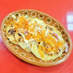 PUPUSA PUNCH Dig into a platter of fresh and hot cheesy pupusas that can include beans, pork, jalape&ntilde;os, or an upcoming addition of an edible South American flower called loroco. - PHOTO COURTESY OF AZTECA MARKET