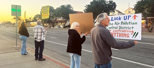 PROTEST MARCH Grover Beach community members took to the intersection of Grand Avenue and 8th Street with signs to protest higher water rates before marching to City Hall to continue their protest during the Nov. 13 City Council meeting. - PHOTO BY SAMANTHA HERRERA
