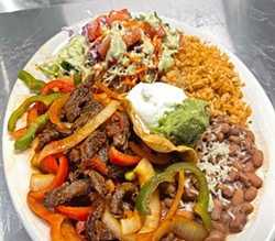 FAJITA HEAT Beef fajitas are one of the three fajita options available at Hanna's Mexican Fusion Restaurant. A fajita plate comes with rice, pinto beans, sour cream, and Hanna's salad, made with the restaurant's cilantro and vinegar dressing. - PHOTO COURTESY OF HANNA'S MEXICAN FUSION RESTAURANT