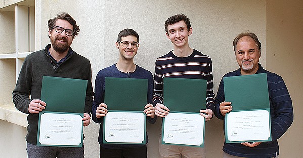 ONGOING INTEREST Cal Poly Associate Professors of Computer Engineering Joseph Callenes-Sloan (left) and Electrical Engineering Majid Poshtan (right) pose with students Braden Wicker (center left) and Michael Tuttle (center right) after their research on power grid cyber security won an award at a Washington, D.C., conference. The two students were first recruits to try out the professors' now-patented software for heat detection. - PHOTO COURTESY OF MAJID POSHTAN