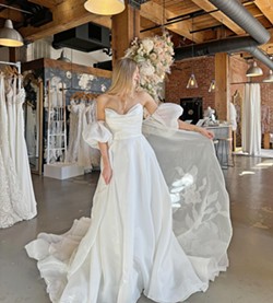 BEYOND THE VEIL Rather than wearing a traditional veil, some brides have opted to wear a cape or wings&mdash;which attach to their shoulders. - PHOTO COURTESY OF MOONDANCE BRIDAL