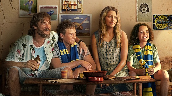 FAMILY TIES (Left to right) Lyle (Travis Fimmel), Gus (Lee Tiger Halley), Frances (Phoebe Tonkin), and Eli (Felix Cameron) work to hold their family together in crime-addled 1980s Australia, in the Netflix miniseries Boy Swallows Universe. - PHOTO COURTESY OF NETFLIX