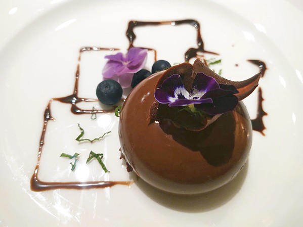OFTEN SOLD OUT Pastry chef Florencia Breda supplies some of Mirazur's desserts, like this Theobroma comprising a 66 percent dark chocolate mousse and cocoa glaze. - PHOTO BY BULBUL RAJAGOPAL