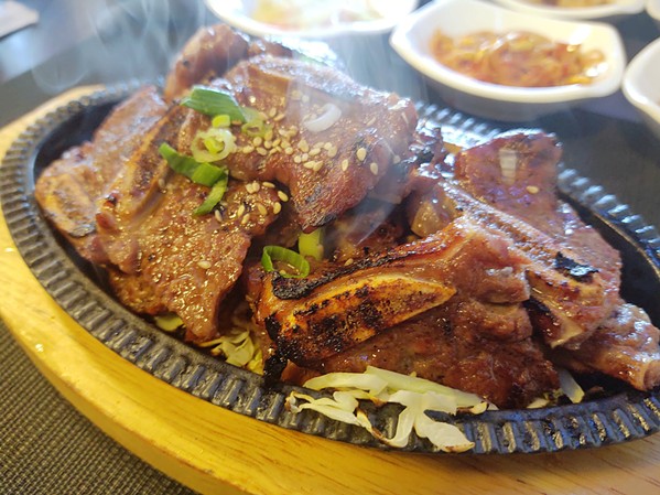 DITCH THE FORK Hana's beef galbi short ribs arrives on a sizzling hot plate accompanied by a bowl of rice. It's best to clean off the bones using your fingers. - PHOTOS BY BULBUL RAJAGOPAL
