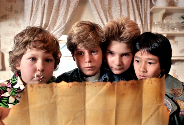 GOONIES NEVER SAY DIE! Left to right: Chunk (Jeff Cohen), Mikey (Sean Astin), Mouth (Corey Feldman), and Data (Ke Huy Quan) embark on a search for hidden treasure, in the 1985 comedy adventure The Goonies, screening July 20, in the Bay Theatre. - PHOTO COURTESY OF CLARK FILM BUYING