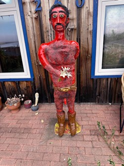 FRIEND OR FOE Located outside of artist Kirk Psenner's home studio in Morro Bay, a 6-foot-tall Mexican Ranchero holds flowers in front of him and a gun behind him. Find more of his work on display at Cruise Control Gallery in Cambria through Aug. 14. - PHOTOS COURTESY OF KIRK PSENNER