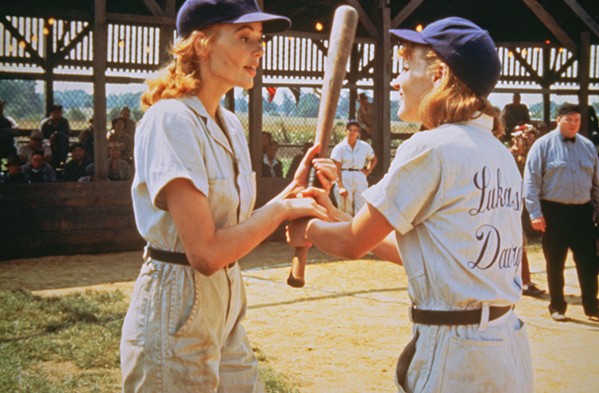 THERE'S NO CRYING IN BASEBALL! Geena Davis (left) stars as catcher Dottie Hinson and Lori Petty as her sister, pitcher Kit Keller, in A League of Their Own, screening at The Palm Theatre on Aug. 24 through 26. - PHOTO COURTESY OF COLUMBIA PICTURES INDUSTRIES, INC.