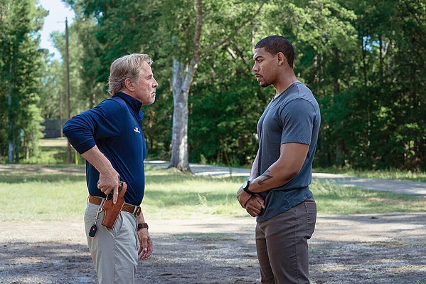 CORRUPTION JUNCTION Chief Sandy Burnne (Don Johnson, left) uses the power of civil forfeiture to steal cash from former Marine Terry Richmond (Aaron Pierre), who's in town to bail out his cousin, in Rebel Ridge, streaming on Netflix. - PHOTO COURTESY OF NETFLIX