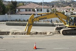 CLOSURE? :  An excavator digs part of a trench near the location where two Teichert Construction employees drowned in 2008 while working on the Nacimiento Pipeline project. The foreman on duty the day they men died was recently sentenced to probation for involuntary manslaughter. - FILE PHOTO BY STEVE E. MILLER