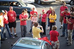 T-SHIRT FLASH MOB :  More than two dozen people assembled in the New Times parking lot on Aug. 20 to prepare for a flash mob that involved taking off their shirts at Farmer&rsquo;s Market. - PHOTO BY STEVE E. MILLER