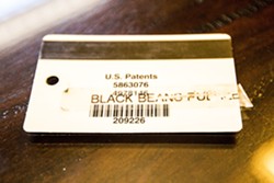 &lsquo;BLACK BEANS RULE&rsquo;:  Janeka Samuels, who is black, alleges her supervisor gave her this nametag with the words &ldquo;black beans rule.&rdquo; - PHOTO BY HENRY BRUINGTON