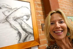 CLOTHING OPTIONAL:  Christine Cortese poses by one of her charcoal drawings in Assets, a studio that teaches barre, as in ballet barre, workouts. The studio is also full of Cortese&rsquo;s figurative oil paintings. - PHOTO BY GLEN STARKEY