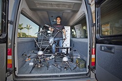 SELLING DRONES:  Jason Lee sells Unmanned Aerial Vehicles (UAVs) for as little as $40 at his shop, Sky Pirate, in Pismo Beach. He believes that the rapid proliferation of drones demonstrates a need for regulations to govern their use. - PHOTO BY DAVID MINSKY