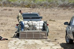 INTRUDERS! :  Several agencies cooperated on investigating a panga beached near San Simeon on Sept. 6. They arrested 20 suspects and seized more than 3,000 pounds of marijuana. More images are available on our Slideshow page. - PHOTOS BY STEVE E. MILLER