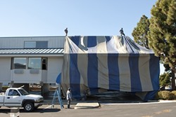 TARP-E DIEM:  A team of six workers from Coastal Fumigation, a Santa Maria-based pest-control company, worked to tent and fumigate the Blue Sail Inn in Morro Bay on Dec. 4. - PHOTO BY STEVE E. MILLER