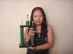 TROPHY MOM :  Maria Hernandez holds a trophy she won as the first student in Atascadero High School history to earn all her credits in two years. - PHOTO COURTESY OF ECONOMIC OPPORTUNITY COMMISSION