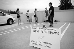 PDA :  One of the stops along the way for Portable Dance Assembly was the top level of the Marsh Street parking garage, where the dancers performed while cars drove by. - PHOTO BY STEVE E. MILLER
