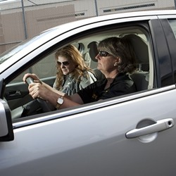 MOBILE OFFICE :  Cathy Bianchi (driver) and Denise Braun spend a great - amount of time driving from location to location in the county to help various police agencies and the courts deal with people with mental health problems.
