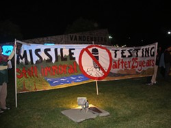 TAKING A STAND :  Dennis Apel, McGregory Eddy, and Father Steve Kelly were arrested during a protest against missile testing such as the one pictured. - PHOTO BY NICHOLAS WALTER
