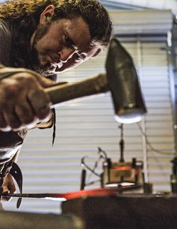 TINKER TAILOR :  Randolph hammers the scorching steel to draw it out and elongate it. - PHOTO BY KAORI FUNAHASHI