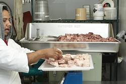 6: :  Using a grinder from 1967 that Antonio refurbished, Tesero adds a specific mixture of 20% pork belly and 80% shoulder and leg meat to begin the process of making the salamis.