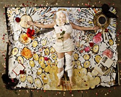 SMILE! :  Painter Josephine Crawford lies inside the outline of herself in her mixed media art piece The Big Bang. Artist Lena Rushing created the disturbingly accurate portrait on her face. - PHOTO BY STEVE E. MILLER