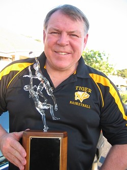 PROUD HOOPS COACH :  Warren Hooper of Hooper Studios recently sculpted the trophy at the center of San Luis Obispo and Mission College Prep high schools&rsquo; basketball rivalry. SLO High assistant basketball coach Kirby Gordon (pictured with the trophy) called it &ldquo;exquisite.&rdquo; - PHOTO COURTESY OF KIRBY GORDON