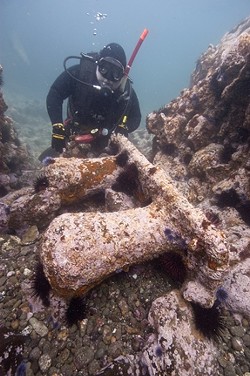 SUNKEN TREASURE :  Diver Patrick Smith behind a massive mooring bit. The sheer size let the team know they were looking in the right place. - PHOTO COURTESY OF ROBERT SCHWEMMER
