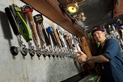 LIBERATE THE FLAVOR :  Bar manager Tyler Clark keeps 20 taps connected to a rotating supply of the world&rsquo;s best beers at the newly opened Libertine Pub, 801 Embarcadero Road. - PHOTO BY STEVE E. MILLER