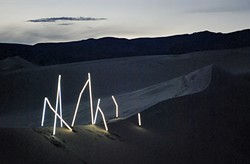 BRIGHT LIGHT:  Illume no. 1, a radiant photo collection crafted by SLO design duo Matt Shara and Kory Worl, is on display now at Kreuzberg through August. Pictured, the artists&rsquo; bright installation glows against a Panamint Springs desert backdrop. - PHOTO COURTESY OF MATT SHARA AND KORY WORL