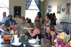 FACES IN THE CROWD :  About 40 or 50 people gathered throughout the afternoon for Linda Castellon&rsquo;s art opening at Sustenance Cooking Studio. - PHOTO BY GLEN STARKEY